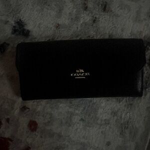 Black and gold coach wallet , used once very beautiful no marks or scratch’s .